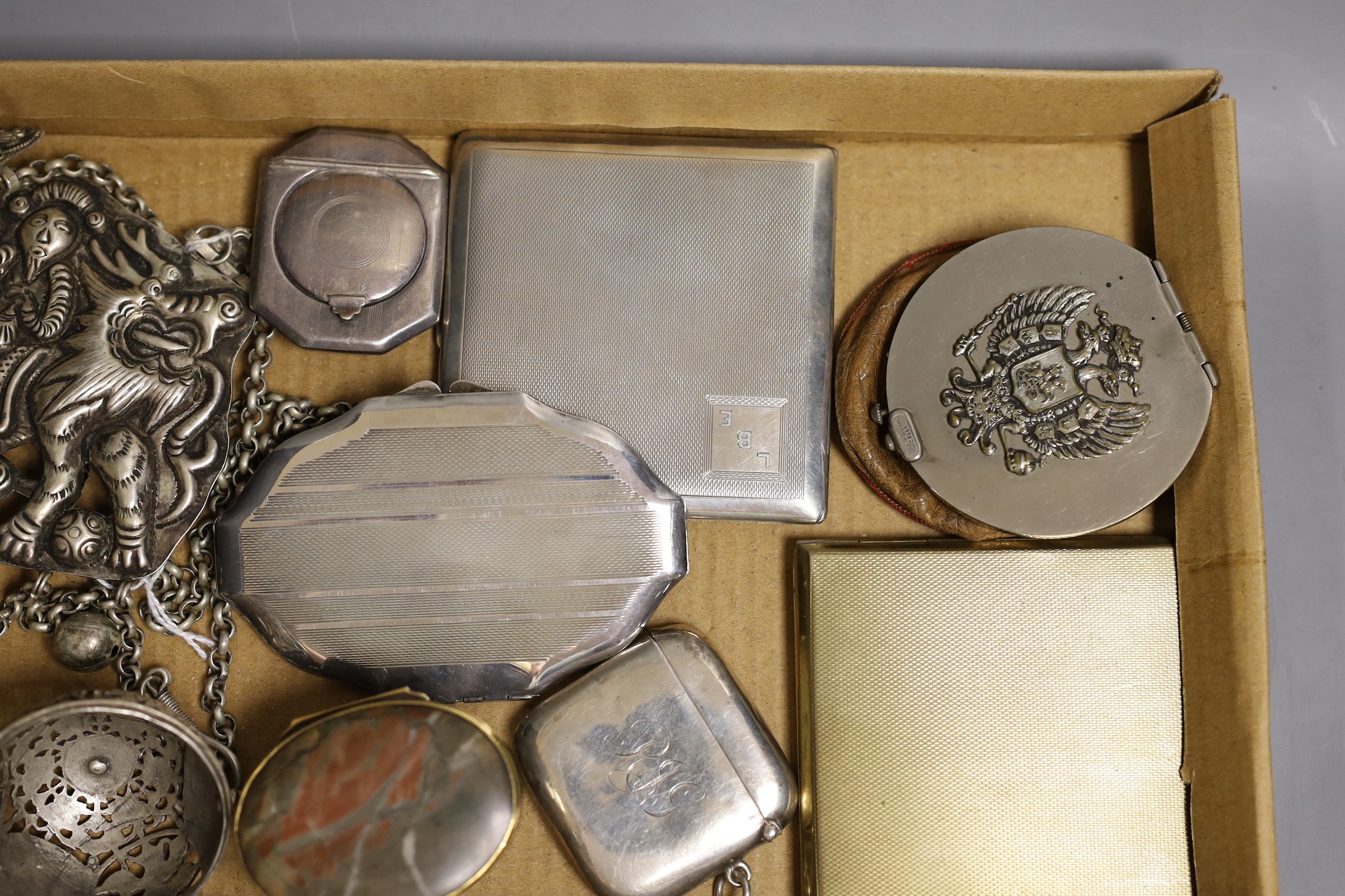An engine turned silver cigarette case, two silver compacts and a vesta case, gross 7oz, an 18th century gilt mounted hardstone snuff box (a.f.), and sundries